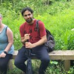 members sat on a wooden bench built by a member