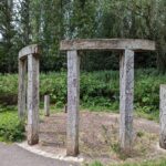 wooden art work at side of canal