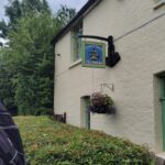 White brick building with hanging sign. The kings lock tea room