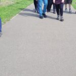 team members walking along path at the meadows