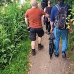 team members walking along tow path of canal