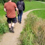 Two club members walking down a winding path