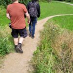 Two club members walking down a winding path