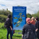 Club members gathered around the Watermead Country Park sign