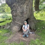 The captain sat in front of a very old tree